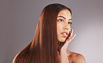Woman, long hair and face for skincare, facial or beauty cosmetics against a gray studio background. Attractive female touching skin in self love or haircare for cosmetic keratin treatment on mockup