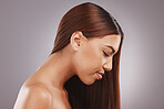 Face, salon and hair with a model black woman in studio on a gray background for natural treatment. Aestehtic, beauty and haircare with an attractive young female posing to promote keratin benefits