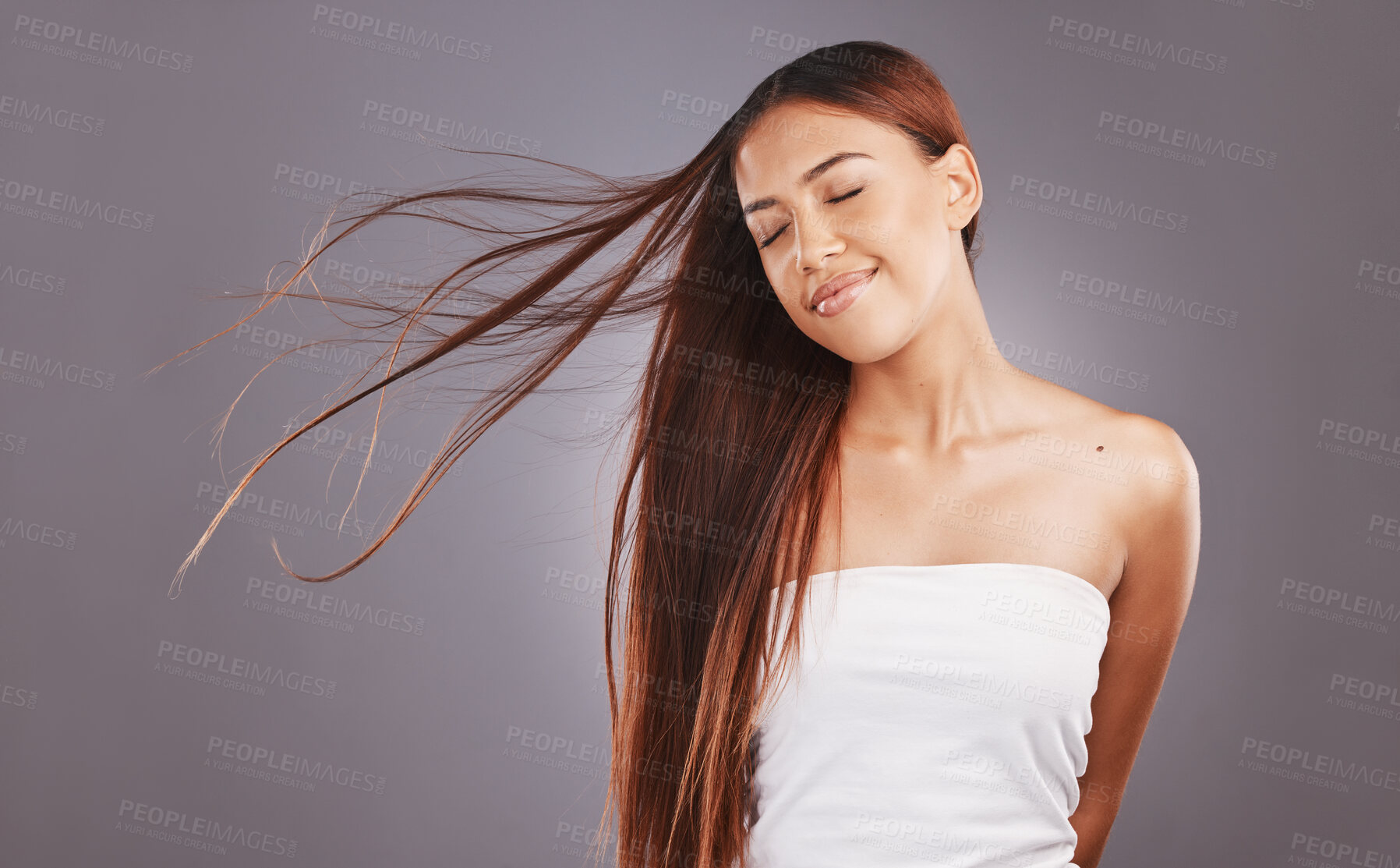 Buy stock photo Salon, hair and hairstyle by woman with care, glow and healthy skincare isolated in a studio gray background. Young, skin and natural beauty model smile due to keratin treatment for haircare