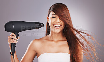 Buy stock photo Beauty, hairdryer and woman salon smile, happy and excited isolated against studio gray background. Hairstyle, model and natural hair female with self care, haircare and drying or styling