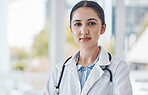 Leadership, woman and portrait of a doctor in the hospital after a healthcare consultation. Confident, young and proud professional female medical worker standing in a medicare clinic after a checkup