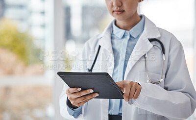 Buy stock photo Digital tablet, healthcare and doctor doing research in the hospital for a diagnosis or test results. Technology, career and closeup of a female medical worker on a mobile device in a medicare clinic