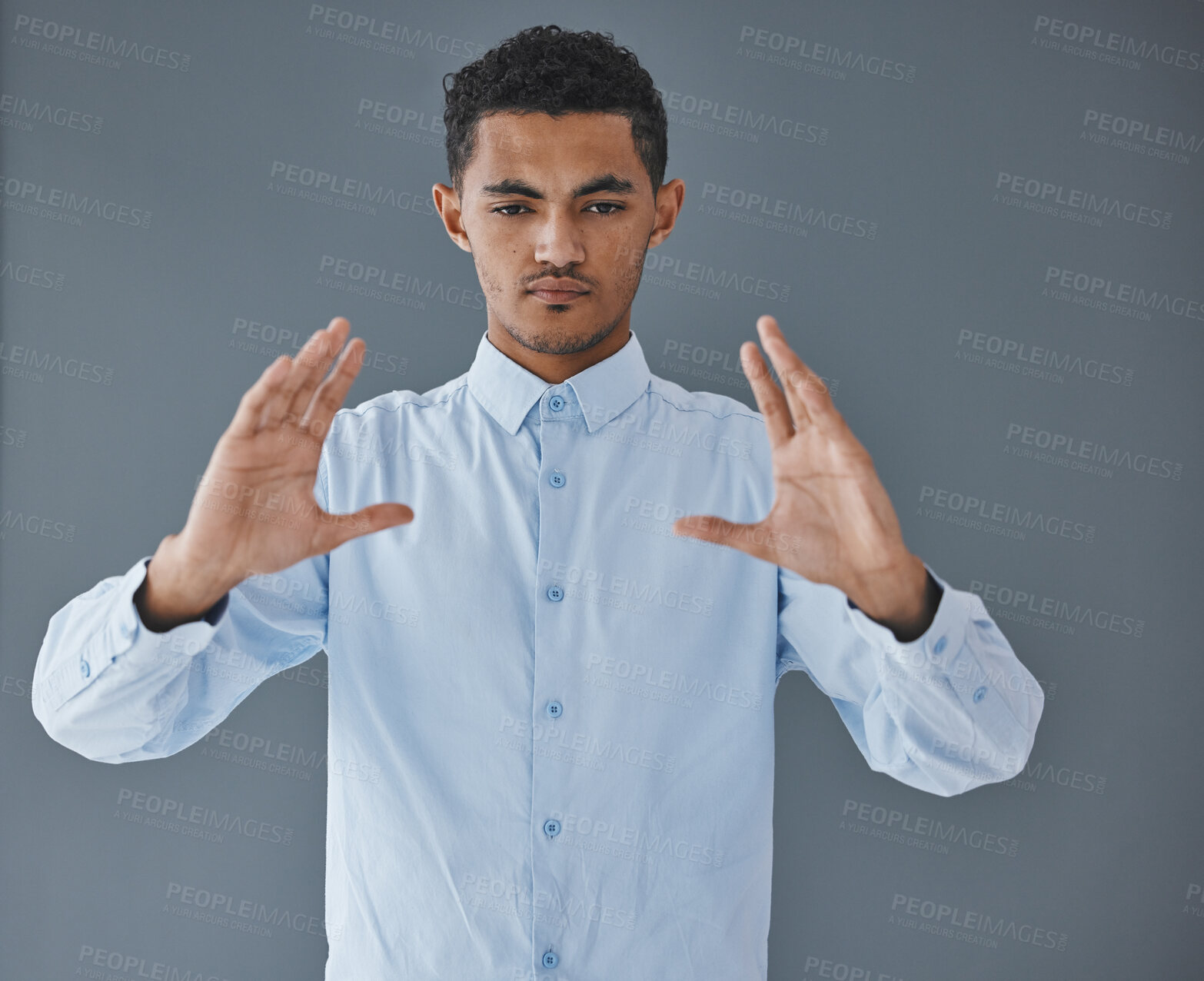 Buy stock photo Product placement, space and hands of a man on a wall for logo marketing and presentation. Sales, showing and serious employee advertising a service, commercial or promotion on a grey background