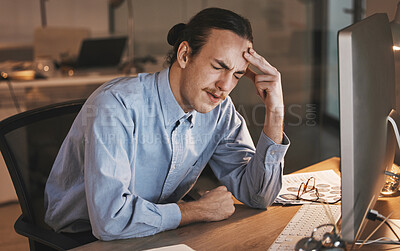 Buy stock photo Man, headache and burnout by computer at night in stress for overworked, anxiety or depression at the office desk. Male employee suffering bad head pain, ache or mental health issues at the workplace