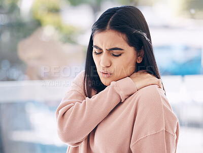 Buy stock photo Neck, pain and mockup with an indian woman holding her shoulder on a glass background while suffering from cramp. Medical, anatomy or muscle and an attractive young female struggling with an injury