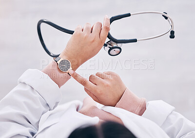 Buy stock photo Top view, hands or doctor checking watch in hospital schedule, late appointment or medical biometrics. Woman, stethoscope or clock time in healthcare wellness visit, annual consulting or clinic visit