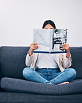 Relax, magazine or woman reading newspaper articles on sofa at home for information or story updates. Press, focus or person relaxing and studying abstract art for knowledge in a publication on couch
