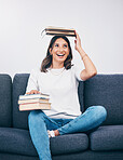 Happy student or woman with books balance on head of study, education or university time management and reading. Knowledge, learning and college person on sofa with history, philosophy or scholarship