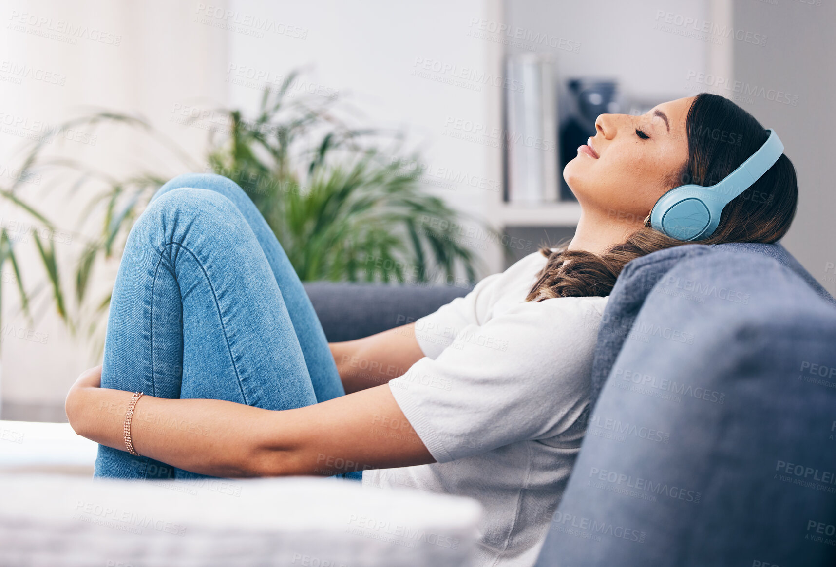 Buy stock photo Music, relax and quiet with a woman in her home, listening to the radio while sitting on the living room sofa. Peace, wellness or headphones with an attractive young female streaming audio in a house