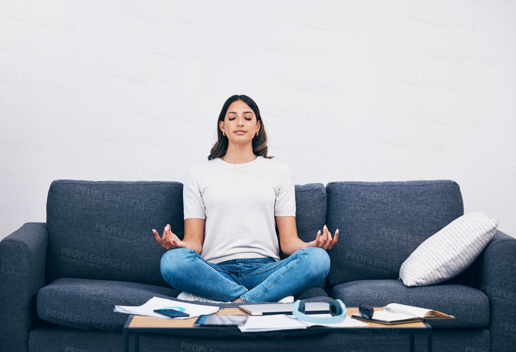 Buy stock photo Studying, meditation and Indian woman in a living room with zen to relax from book learning. Sofa, home and female student meditate on a couch doing yoga for wellness in a house with education book