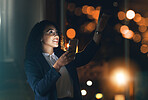 Phone, night and business woman in the office with bokeh lights to work late on a project with a deadline. Technology, dark and professional African female employee working overtime in the workplace.