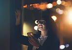 Business woman, phone and night in dark office for communication, network connection and trading. Entrepreneur person with smartphone and bokeh lights for networking, internet search or ai mobile app