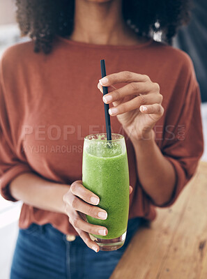 Buy stock photo Hands, glass and smoothie with a black woman drinking a health beverage for a weight loss diet or nutrition. Wellness, glass and drink with a healthy female enjoying a fruit beverage at home
