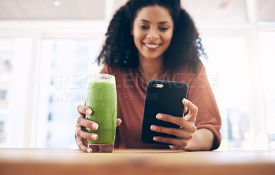 Buy stock photo Hands, smoothie and smartphone with a black woman in the kitchen of her home for health, weight loss or nutrition. Mobile, glass and wellness with a female posting a status update on social media