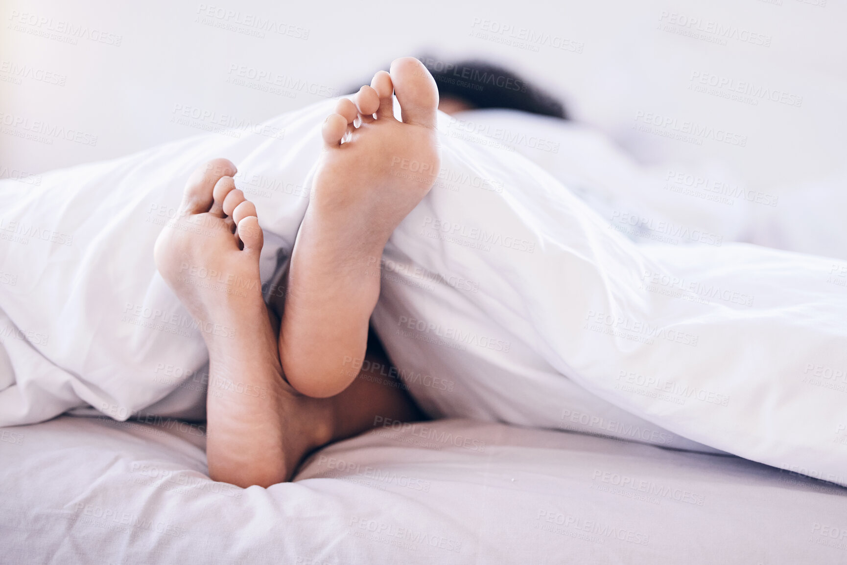 Buy stock photo Woman feet, bedroom and home of a young person in the morning feeling relax and calm. Morning, house and carefree female in a house with foot under blanket on mattress ready for sleep or nap