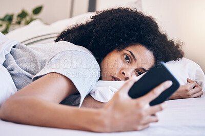 Buy stock photo Cellphone, mental health and woman in her bed with depression while watching videos on social media. Tired, sleepy and depressed female with insomnia networking on a phone in her bedroom at home.