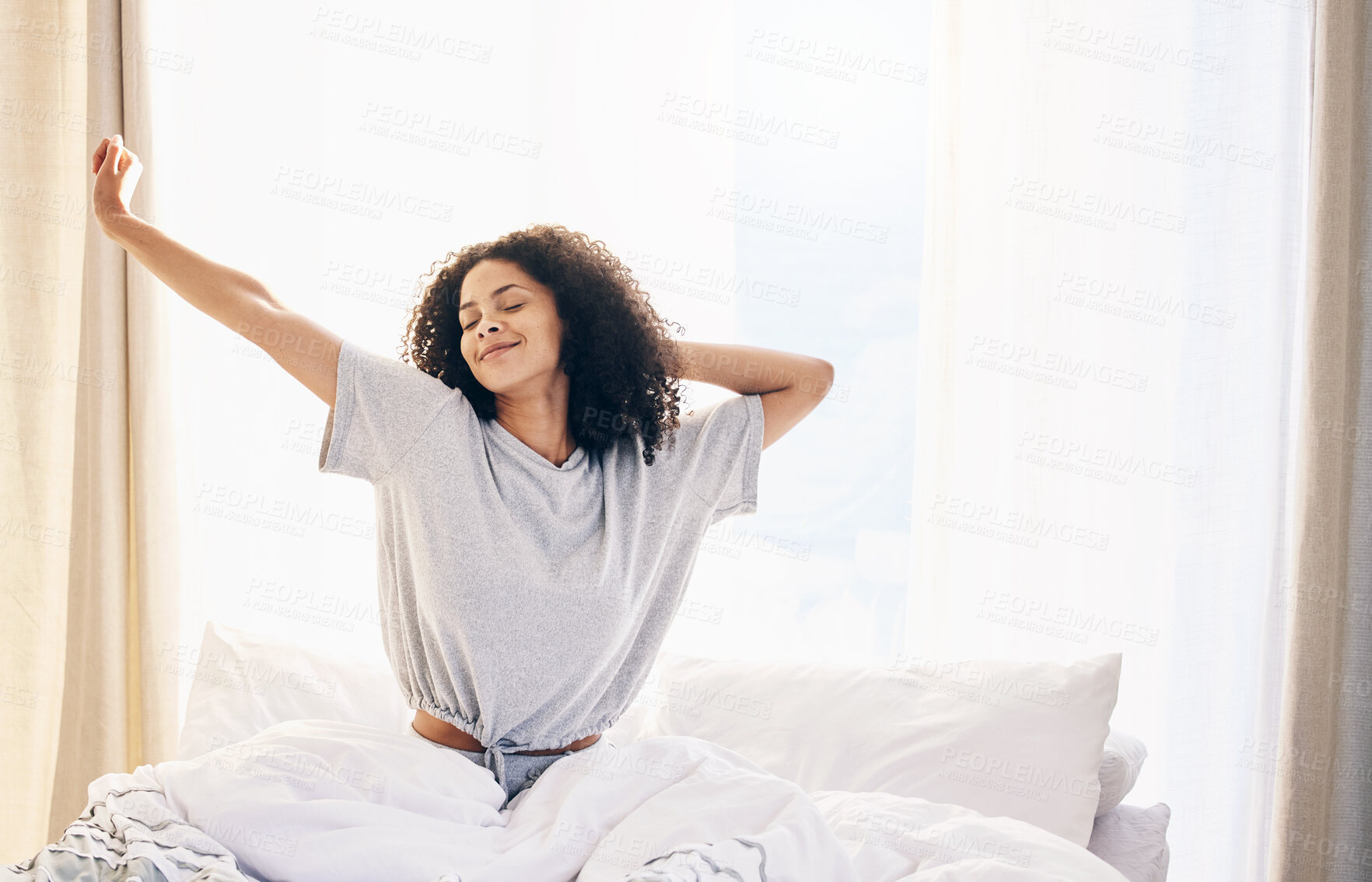 Buy stock photo Black woman, morning stretching and waking up in home bedroom after sleeping or resting. Relax, peace and comfort of happy female stretch after sleep feeling fresh, awake and well rested in house.