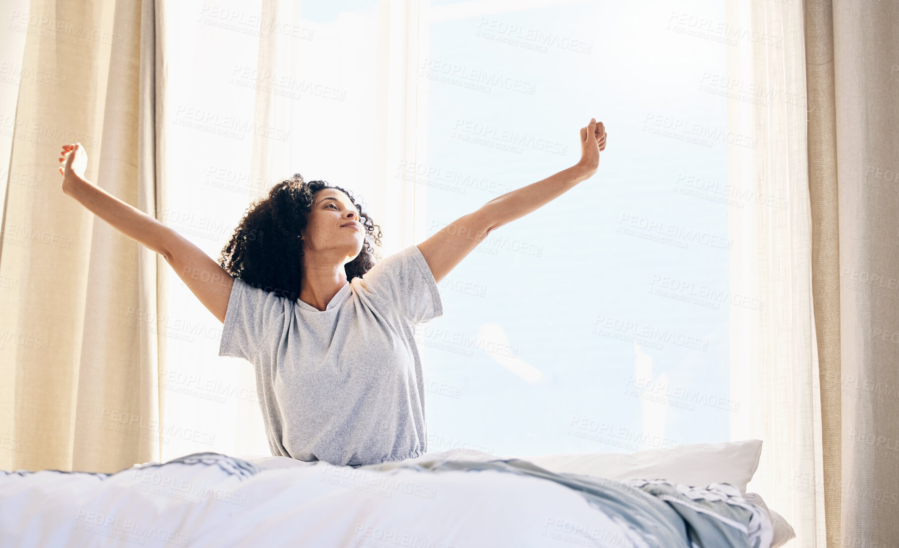 Buy stock photo Black woman, morning stretching and wake up in home bedroom after sleeping or resting. Relax, peace and comfort of young female stretch after sleep feeling fresh, awake and well rested in house.