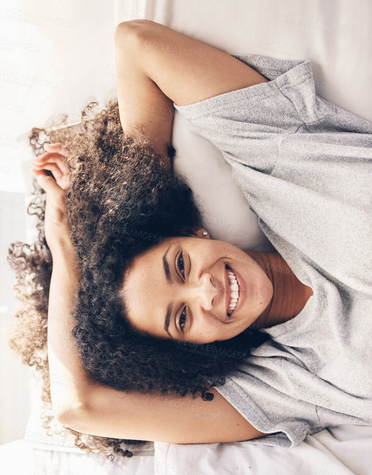 Buy stock photo Black woman, wake up and top view portrait in bedroom after sleeping or resting. Peace, bed relax and comfort of happy female awake after sleep on comfortable pillow and blankets for healthy rest.