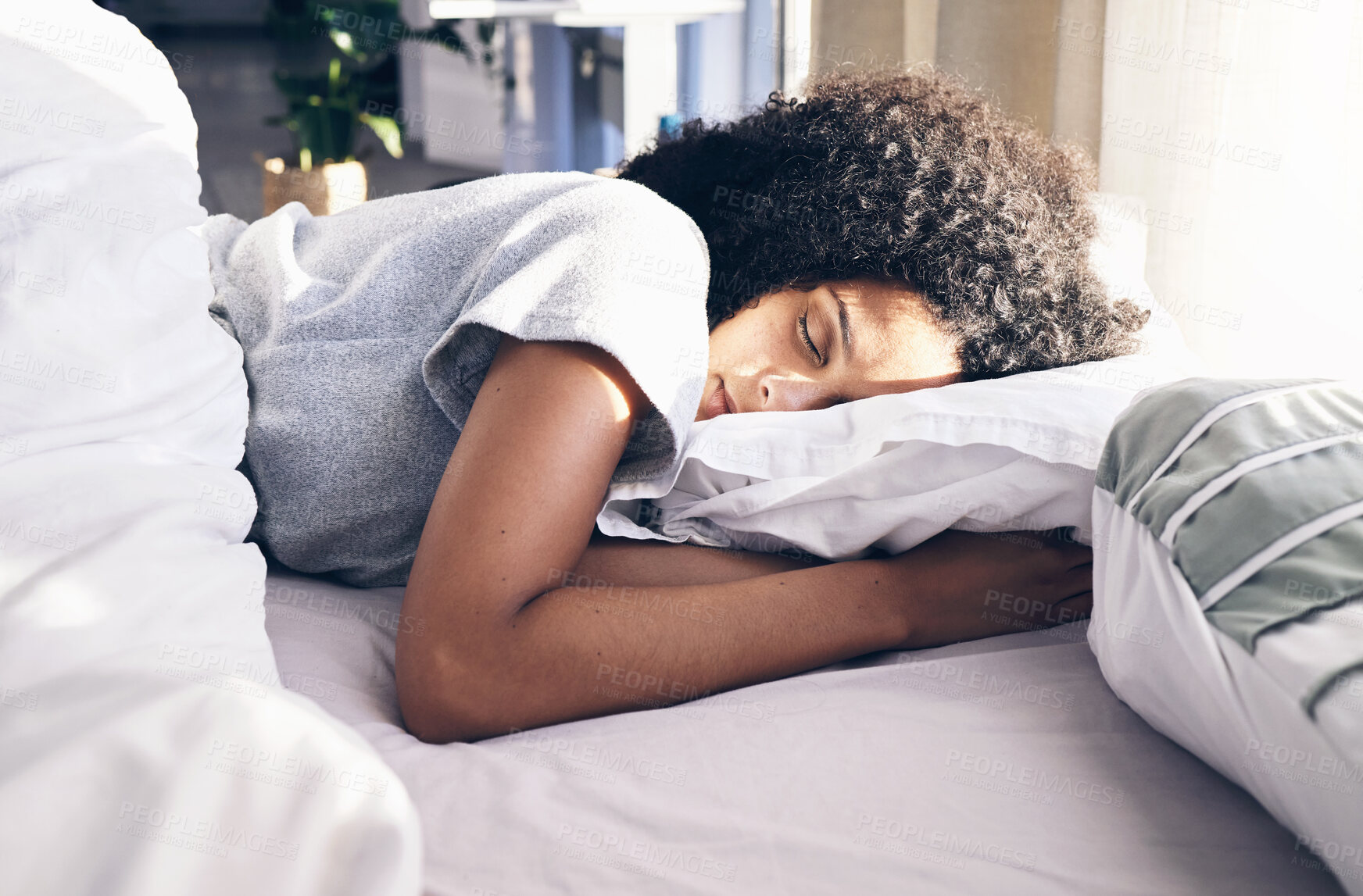 Buy stock photo Sleep, bedroom and relax with a black woman in bed, dreaming or resting in the morning at home. Sleeping, tired and rest with an attractive young female asleep in her house over the weekend