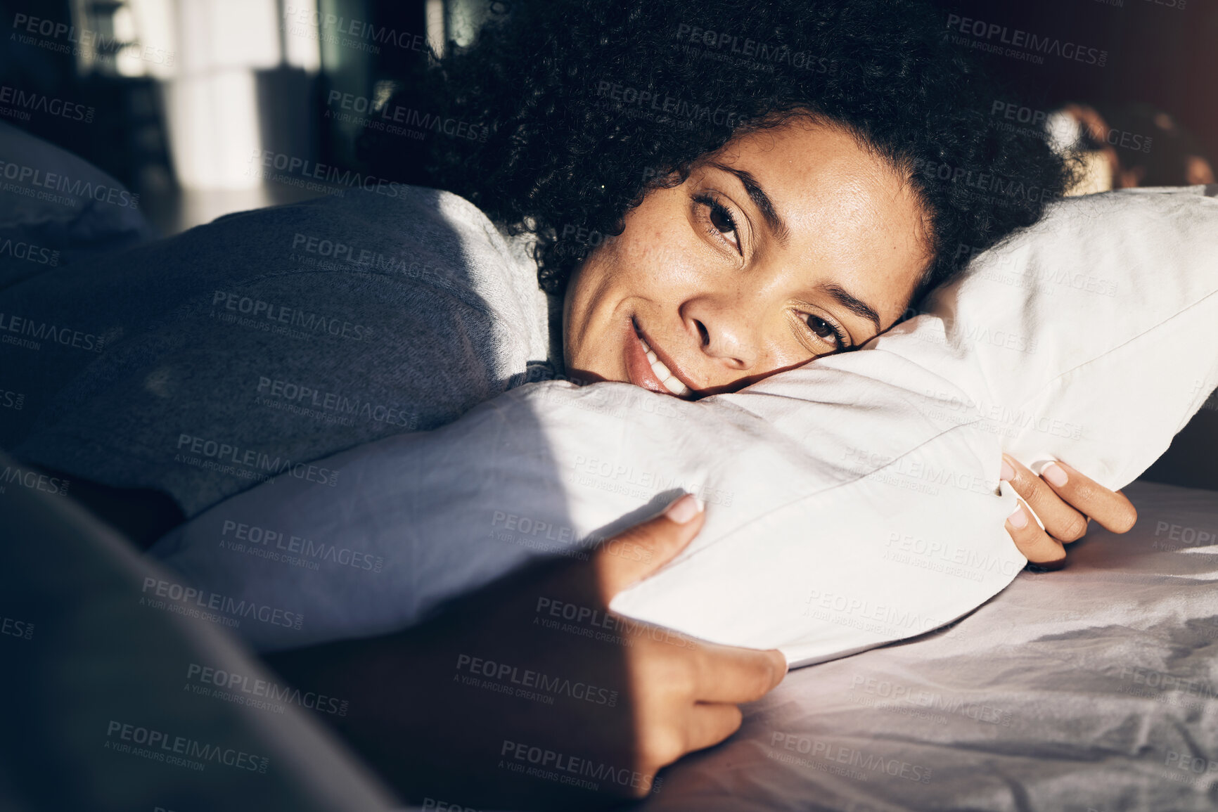 Buy stock photo Portrait, woman in bed and morning with sunlight, smile and ready to start the day, rested and fresh. Face, female and lady in bedroom, sunshine and happiness for vacation, pillow or wake up with joy