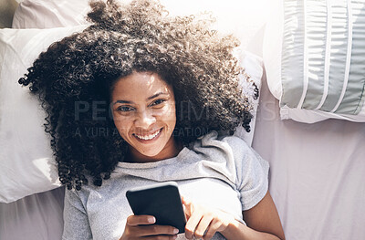 Buy stock photo Black woman, phone and top view in home bedroom for social media, texting or internet browsing in the morning. Portrait, bed relax and female with mobile smartphone for web scrolling or networking.