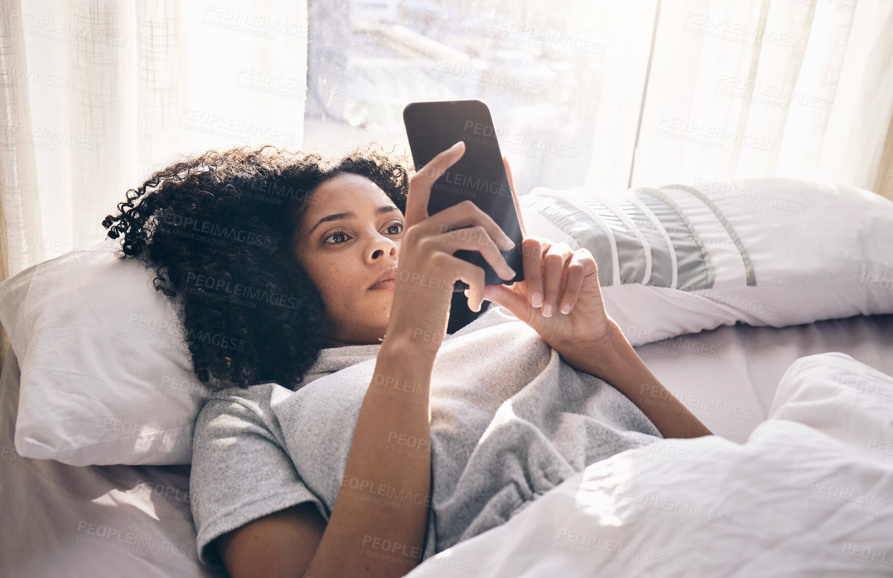 Buy stock photo Phone, black woman and typing in home bedroom for social media, texting or internet browsing in the morning. Technology, bed relax and female with mobile smartphone for web scrolling or networking.