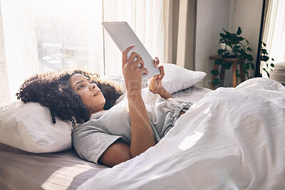 Buy stock photo Relax, tablet and black woman in bed in bedroom for social media, texting or internet browsing in the morning. Technology, home and female with digital touchscreen for web scrolling after waking up.