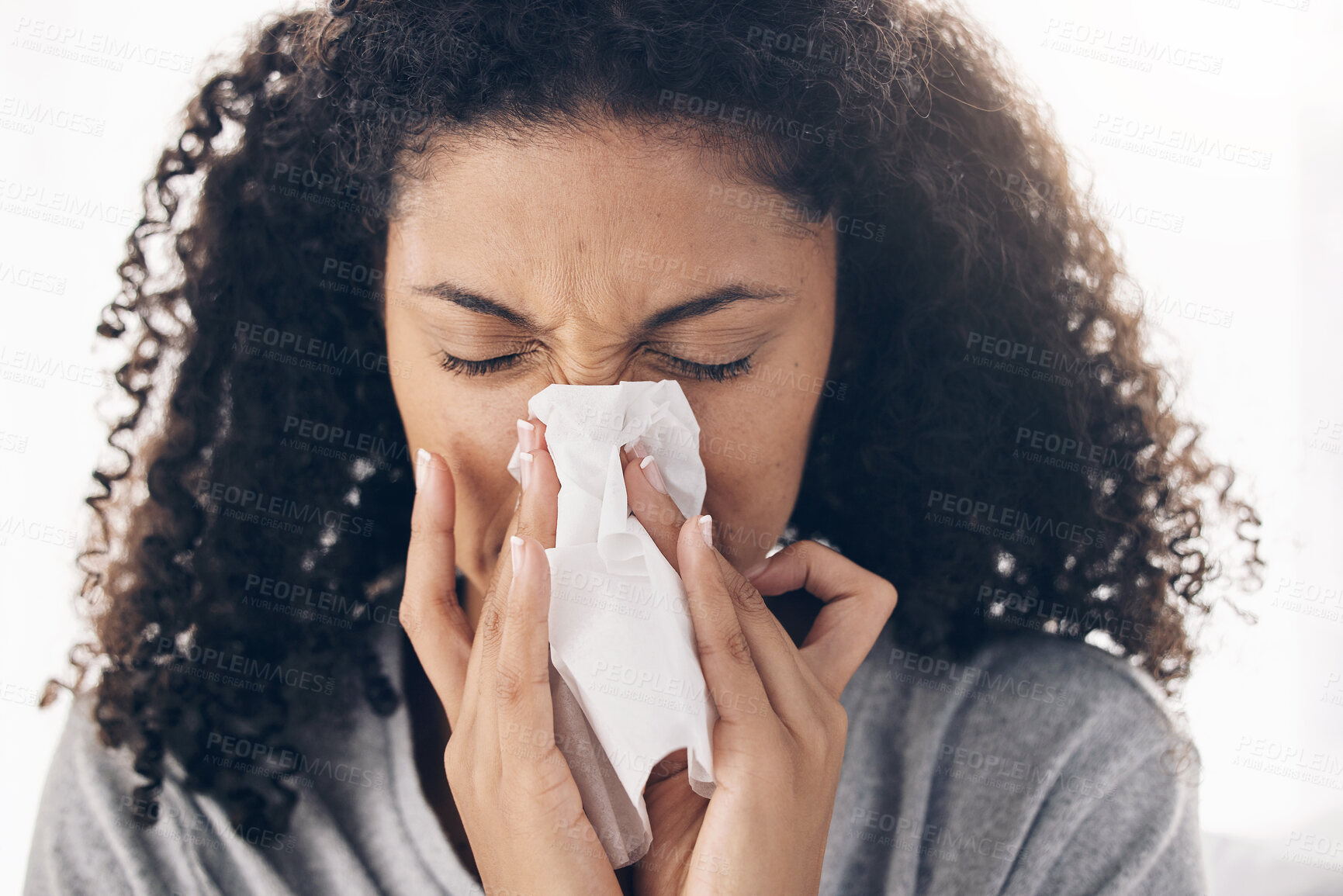 Buy stock photo Black woman, tissue and sneeze of a sick young person blowing nose with toilet paper for safety. Flu, fever and cold of a female feeling tired from sirus infection at home with a health problem 