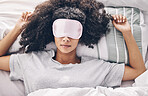 Sleep, relax and black woman in bed with eye mask, dream and rejuvenate body and mind in apartment or hotel. Dreaming, rest and relaxation, tired girl sleeping late on weekend morning in cozy bedroom