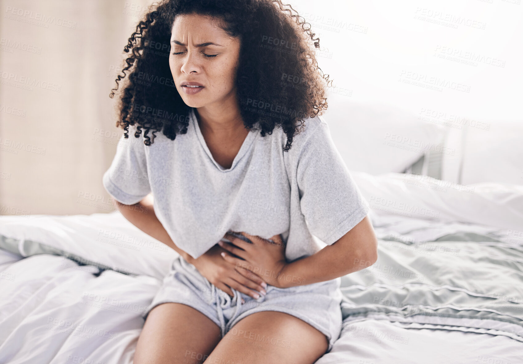 Buy stock photo Abdomen pain, period and black woman in bed with abdominal cramps, menstruation and stomach ache. Health, medical emergency and girl with digestion problem, pms crisis and endometriosis in bedroom