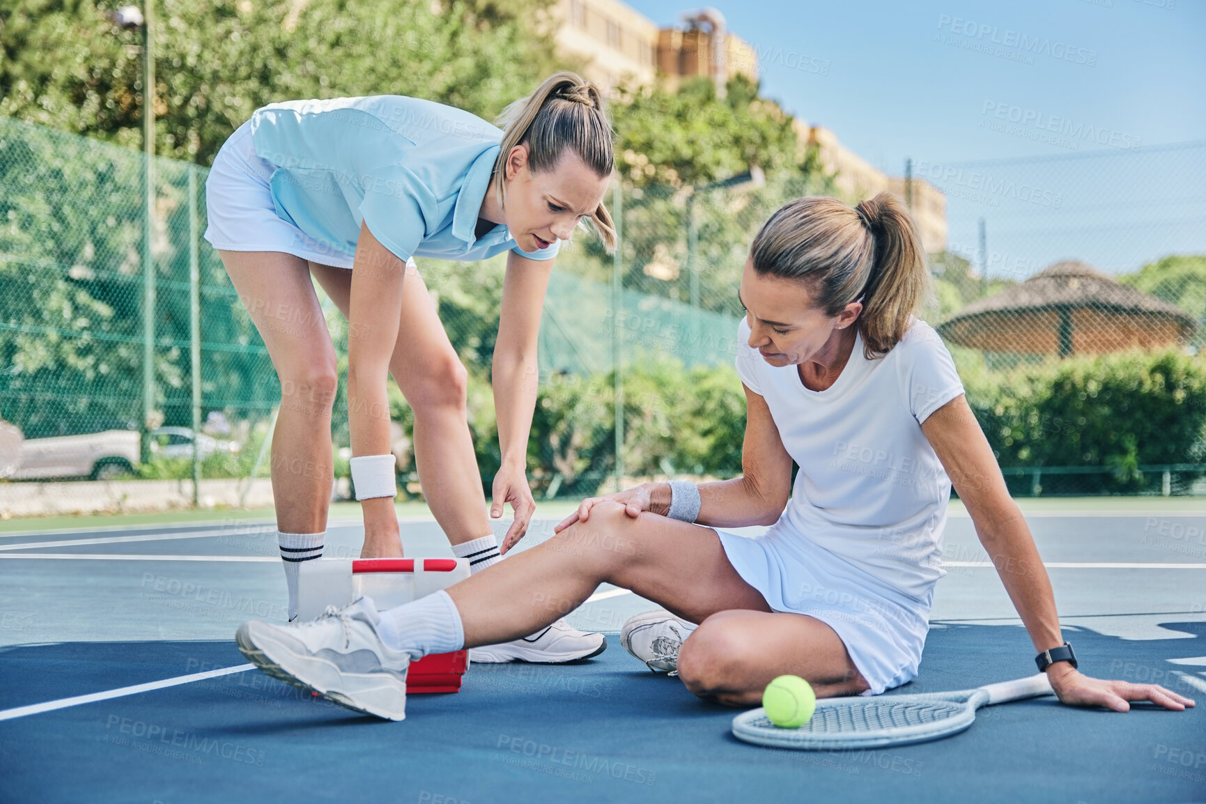Buy stock photo Tennis, medic with first aid and woman with knee pain, torn muscle or inflammation on court while training. Female coach, mentor or help athlete with strain, tender or broken leg with outdoor fitness