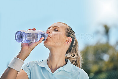 Woman, tennis player and drinking water for hydration after workout, exercise or intense training in nature. Sporty female with bottle for refreshing drink to stay hydrated during sports exercising