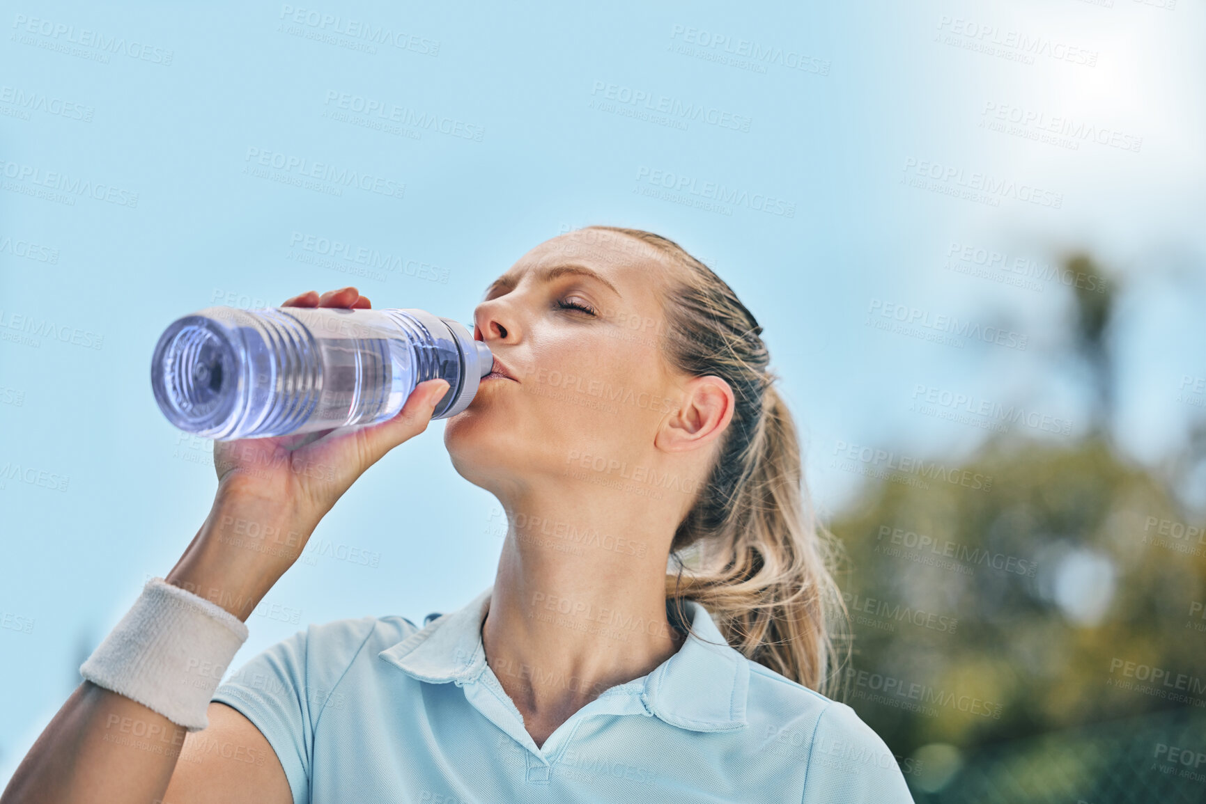 Buy stock photo Woman, tennis player and drinking water for hydration after workout, exercise or intense training in nature. Sporty female with bottle for refreshing drink to stay hydrated during sports exercising