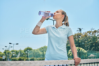 Buy stock photo Woman, tennis and drinking water for hydration after workout, exercise or intense training on court. Sporty female with bottle for refreshing drink, thirst or stay hydrated during sports exercising