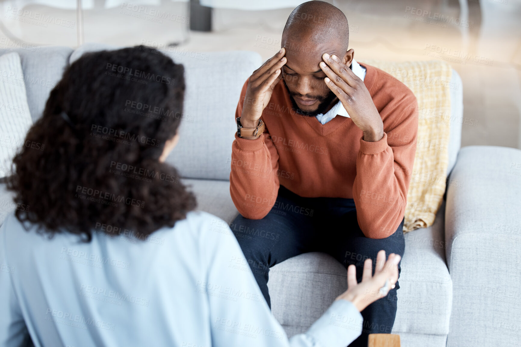 Buy stock photo Black man, mental health and counseling with woman psychologist, stress headache and depression with help. Consultation, doctor with patient and conversation about anxiety problem, sad and depressed