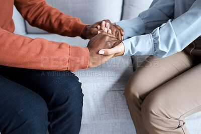 Buy stock photo Holding hands, black couple and therapy help on sofa for support, solidarity and listening for love in relationship. Man, woman and couch for helping hand at psychology, consultation or trust problem