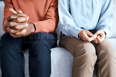 Buy stock photo Hands, nervous and couple in waiting room for results, cancer and bad news, diagnosis and stress. Hand, anxiety and man with woman on sofa for depression, marriage counseling or divorce discussion