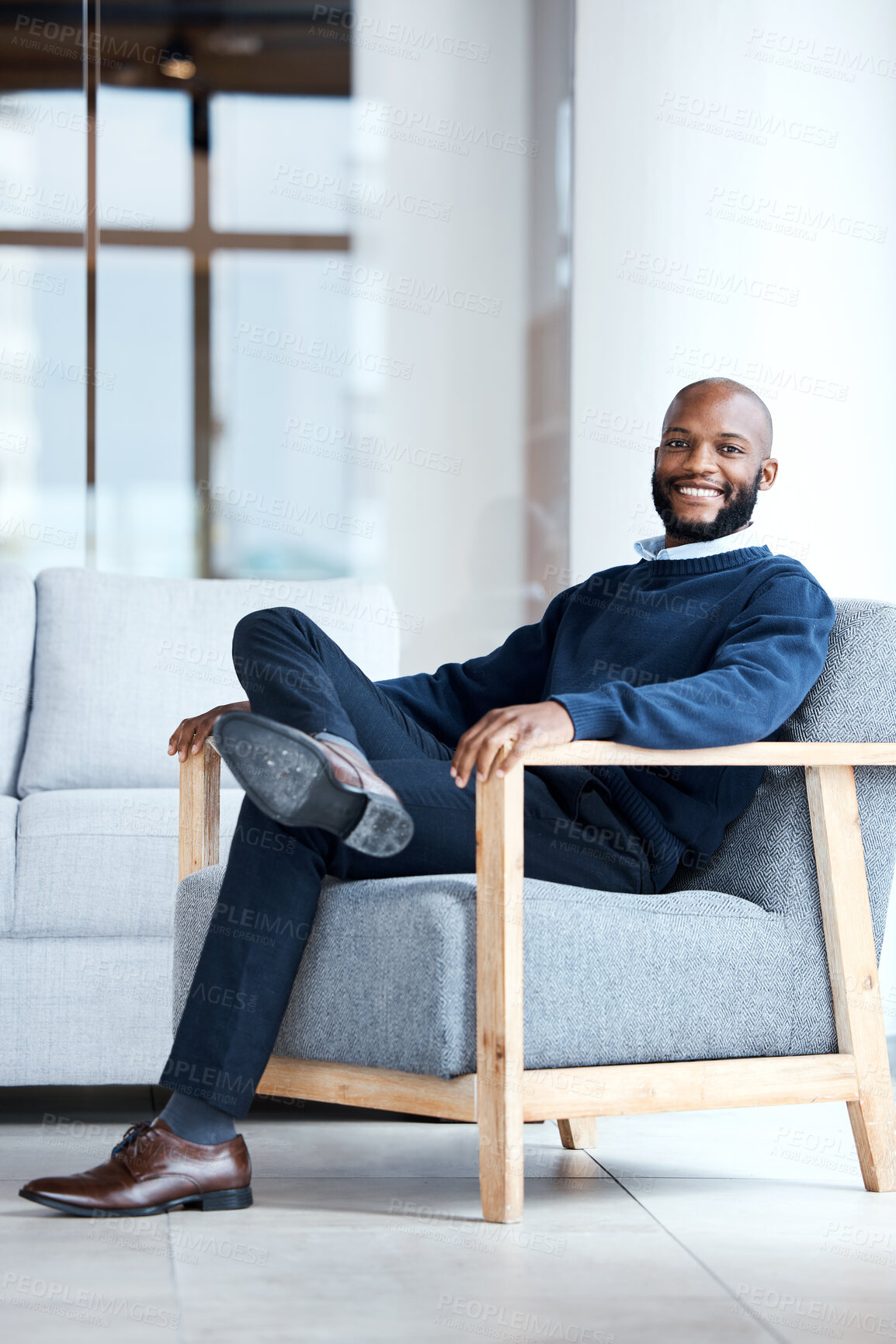 Buy stock photo Portrait, black man in office and waiting on chair, smile and confident for job interview, resting and relax. Face, African American male employee and entrepreneur in workplace, happiness and joyful