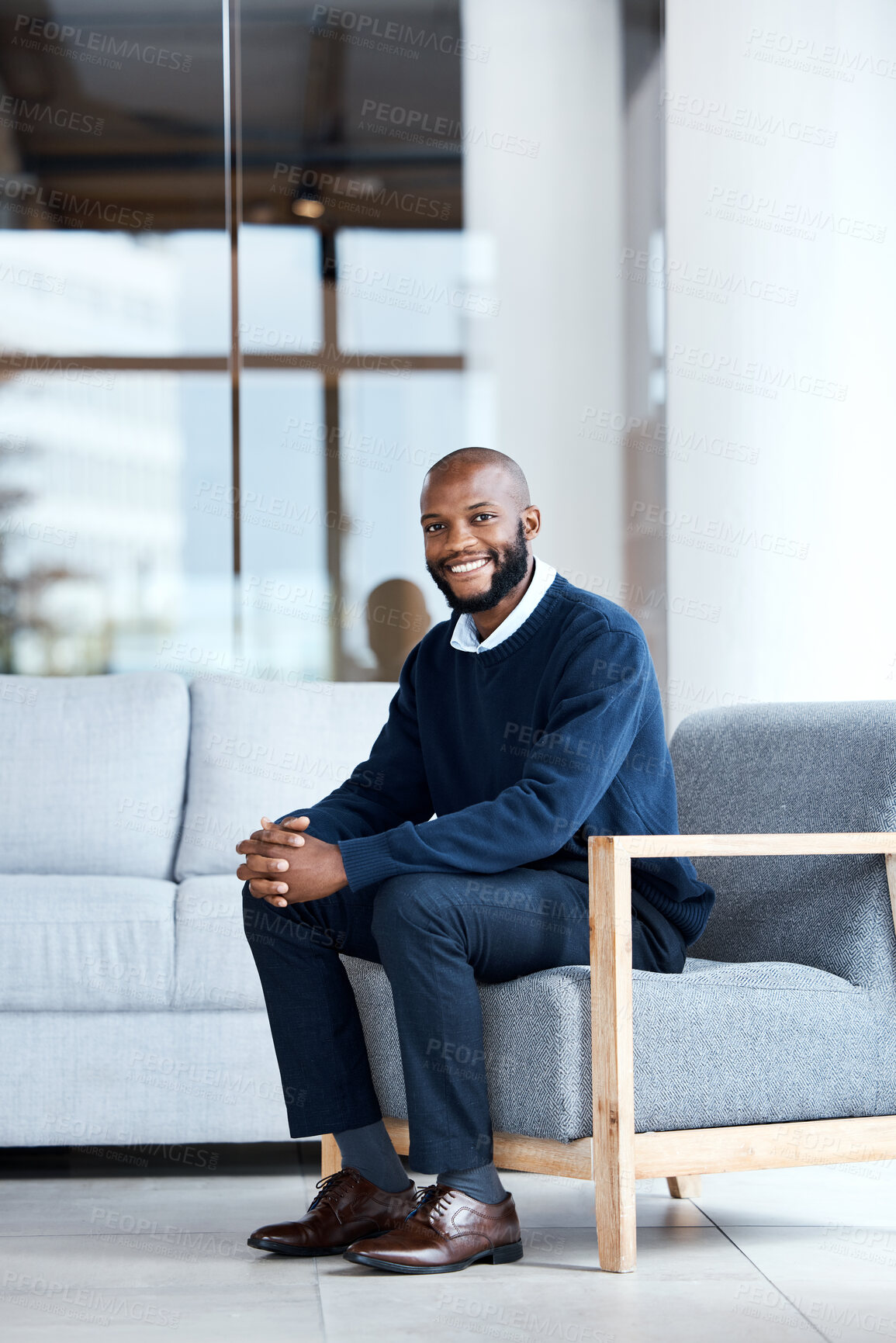 Buy stock photo Man, happy and therapist waiting in chair at workplace for consultation or interview in an office building smiling. Portrait, employee and African American worker with positive mindset and excited