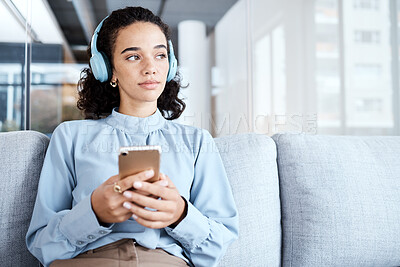 Buy stock photo Music headphones, phone and business woman on sofa in office streaming audio. Cellphone, technology and thinking female employee on couch listening to podcast, radio or sound with mobile smartphone.