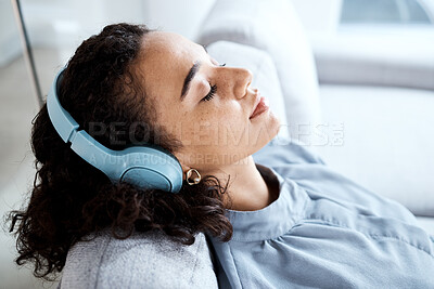 Buy stock photo Face, woman and headphones for listening to music for calm, peace and mindfulness on home couch. Young person on living room sofa listen to podcast, audio or motivation to relax or meditation profile