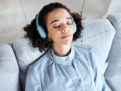 Buy stock photo Headphones, woman and face for listening to music for calm, peace and mental health on home couch. Young person on living room sofa listen to podcast, audio or motivation to relax or meditation above