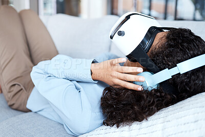 Buy stock photo Virtual reality, metaverse and gaming with a black woman on a sofa in the living room of her home. AI, 3D and VR with a young female gamer using a headset to access cyberspace for a video game