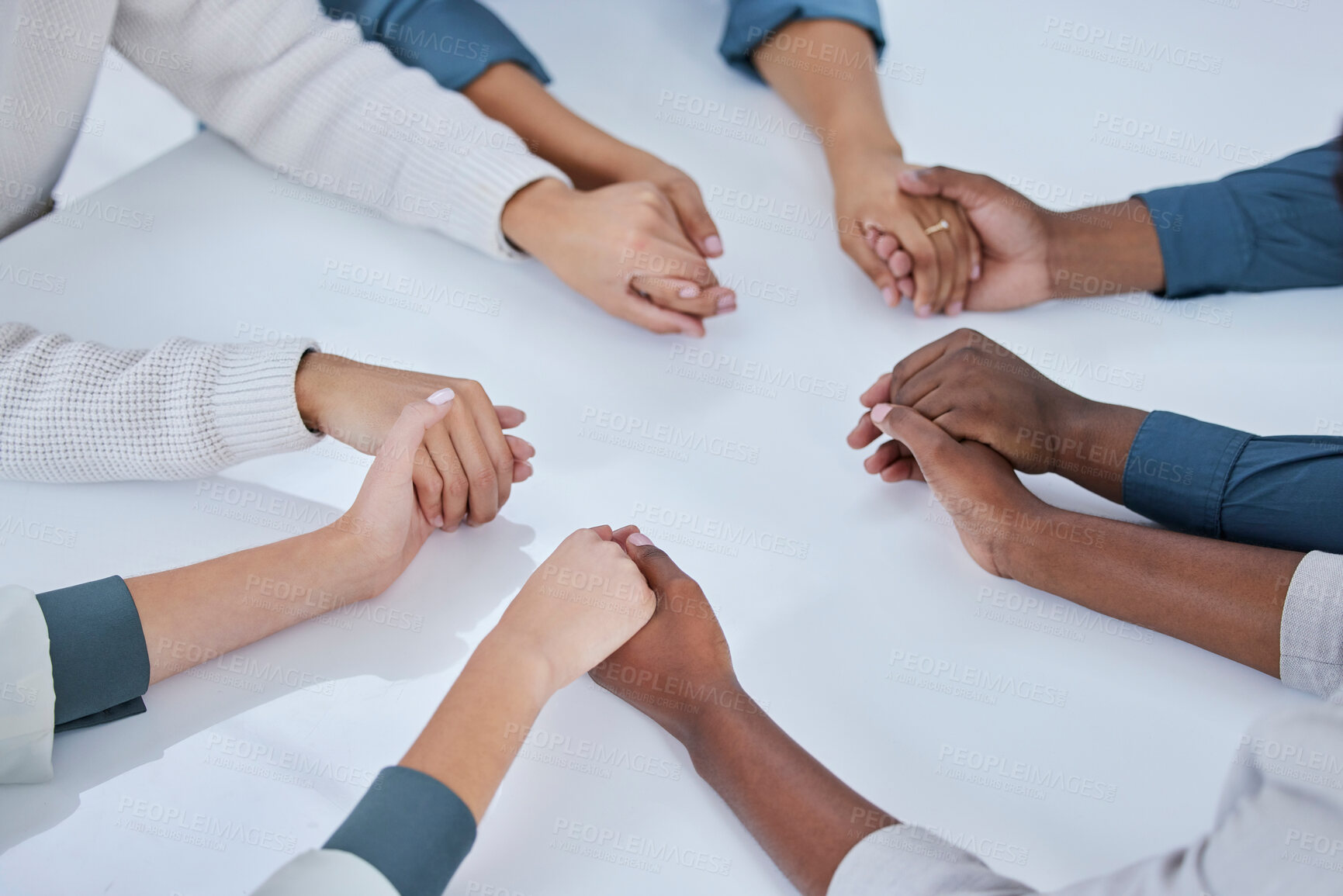 Buy stock photo Business people, holding hands and community in team building, trust or unity together above on table. Hand of group touching in collaboration for mission, support or agreement in solidarity at work