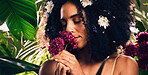 Beauty, skincare and woman smelling flowers in a organic garden for a natural floral face routine. Cosmetic, wellness and female model from Mexico enjoying the aroma of plants in a environment.