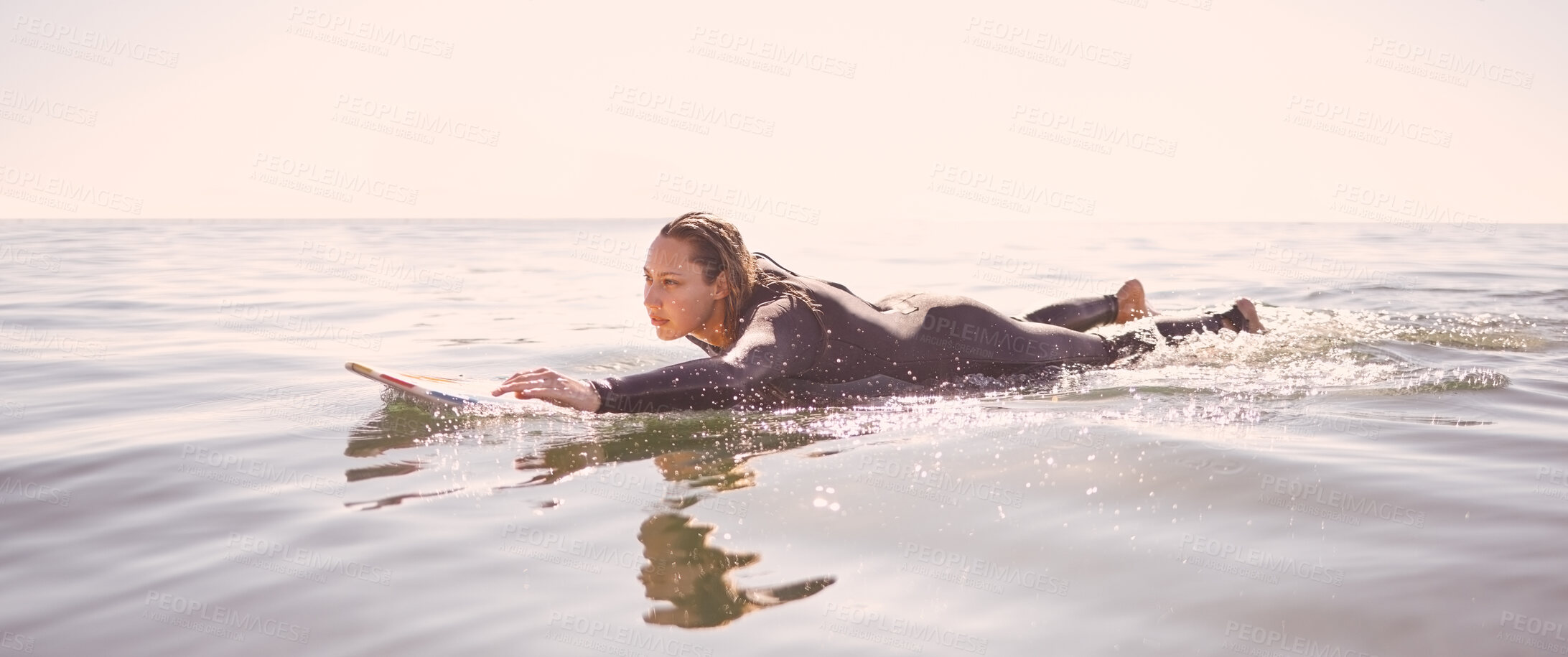 Buy stock photo Surfer, woman and swimming in waves, sea and ocean for summer adventure, freedom and sky mockup. Female surfing on board in water, beach and relax for tropical holiday, nature travel and peace sports