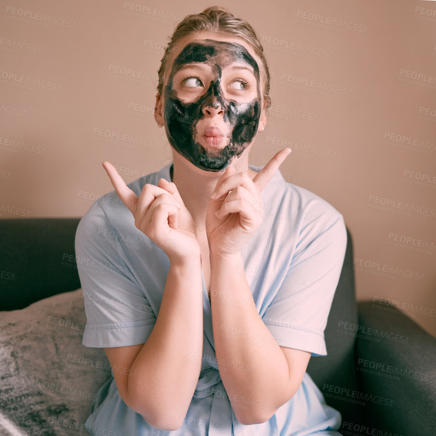 Buy stock photo Skincare, face mask and goofy woman in her house, home or apartment doing morning beauty routine with hand gesture. Portrait, relax and funny female doing facial for self care using charcoal