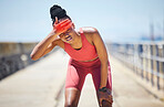 Headache, fever and black woman runner by the sea with fitness, training and running injury. Head pain, sports and athlete with joint, muscle and inflammation problem with blurred background