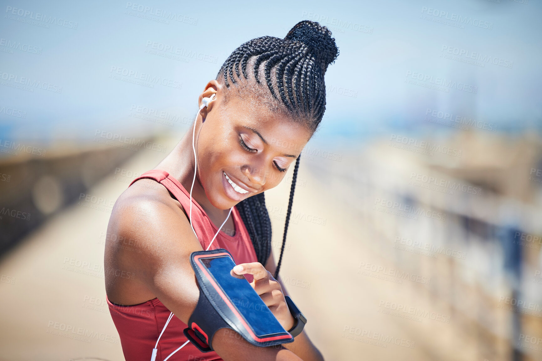 Buy stock photo Black woman, runner and arm band with phone, earphones and motivation for outdoor fitness. Happy female athlete, mobile music and training for exercise wellness, workout energy and sports technology